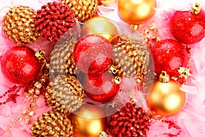 Christmas baubles on pink feather