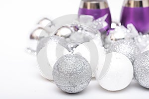 Christmas baubles, violet  wineglass on a white