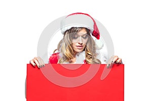 Christmas. Beautiful muscular sexual happy woman in Santa Claus clothes. Keeps blank whiteboard. Isolated on white