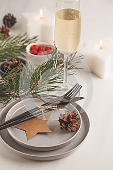 Christmas beautiful table setting with champagne and candles. Ch