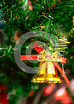 Christmas bells on Christmas tree with red ribbon, giving and celebration holiday, present and happiness,Happy New Year concept.