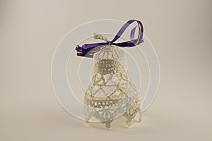 Christmas bells with purple ribbon isolated on white background. New Year`s bell.