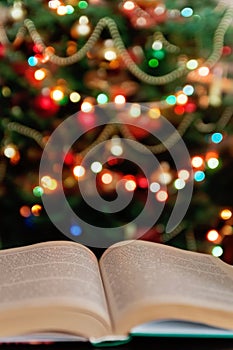 Christmas and bible with blurred candles light background