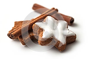 Christmas biscuit shaped star with cinnamon stick on