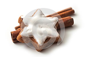 Christmas biscuit shaped star with cinnamon stick on
