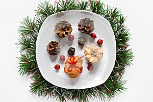 Christmas biscuits on a dish on white background