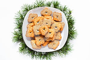 Christmas biscuits on a dish on white background