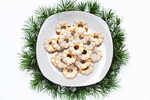 Christmas biscuits on a dish on white background