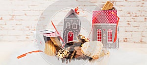Christmas biscuits stylishly and sustainably packaged in cardboard boxes in form of houses.