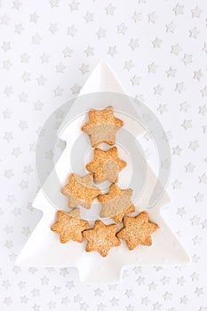 Christmas Biscuits on Tree Shaped Plate on Silver Star Background
