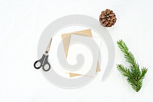 Christmas blank greeting card mock-up scene. Christmas decoration composition on white linen background with blank greeting card