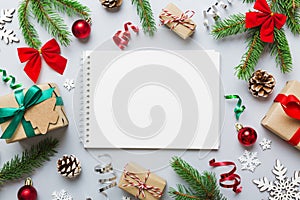 Christmas blank greeting card mock-up scene. Creative layout made of Christmas tree branches and paper card note. Flat