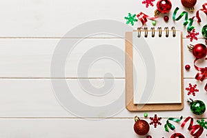 Christmas blank greeting card mock-up scene. Creative layout made of Christmas tree branches and paper card note. Flat