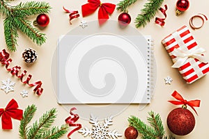 Christmas blank greeting card mock-up scene. Creative layout made of Christmas tree branches and paper card note. Flat