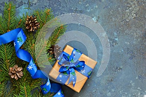 Christmas blue background with gift boxes and xmas tree.