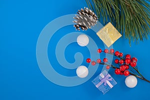 Christmas blue background. Gift or present box and holiday decoration top view. pine cones and decorative snowballs, Happy New Yea