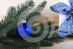 Christmas with blue christmas ball and light-colored wooden background