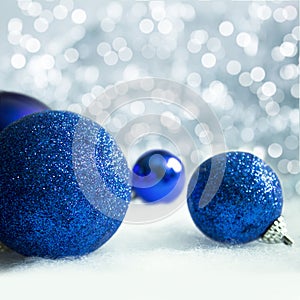 Christmas blue decorations on snow background