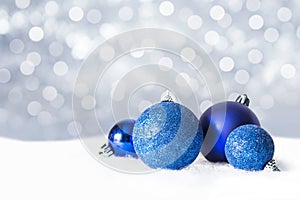 Christmas blue decorations on snow background