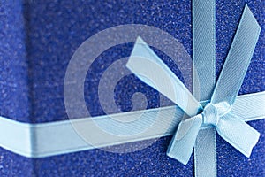 Christmas blue gift box with a ribbon for congratulations . Gift box for Christmas, New Year or Valentine's Day