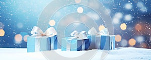 Christmas blue gift boxes with ribbon on snow