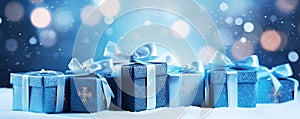 Christmas blue gift boxes with ribbon on snow