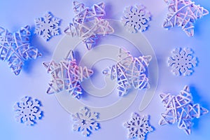 Christmas blue neon background with wooden stars and snowflakes. Holiday greeting card design with gradient lights