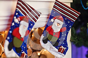 Christmas blue stocking hanging from a mantel or fireplace, decorated for.