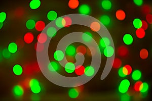 Christmas bokeh background, copy space. Defocused new year bokeh lights, free space. Blurred red and green bokeh.