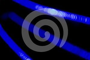 Bokeh blue abstract background with blurred neon light curved lines