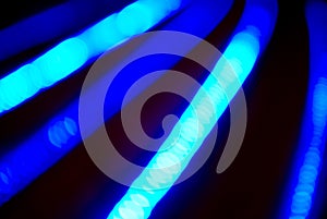 Bokeh blue abstract background with blurred neon light curved lines