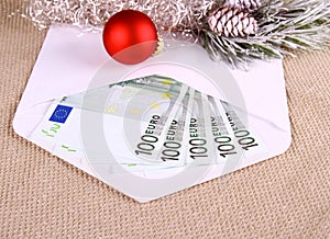 Christmas bonus as five hundred euro in envelope and decor