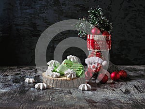 Christmas boot with red balls and tinsel, and festive meringue cookies