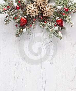 Christmas border with fir branches and  baubles on white shabby wooden board with copy space for text. Flat lay.  Christmas and Ne