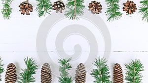 Christmas border. Fir branches, cones on a white rustic background. Horizontal shot