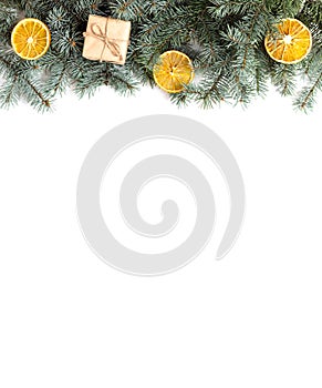 Christmas border with fir branches, gifts and dried oranges on a white background. Christmas concept. Space for text. Top view,