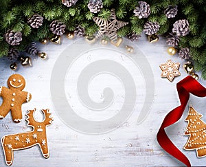 Christmas border with fir branches and pine cones and christmas sweets, treat, christmas cookies