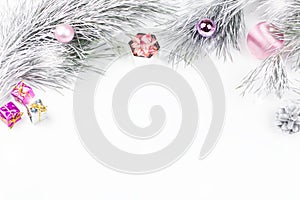 Christmas border with fir branches, presents, christmas ornaments on white background