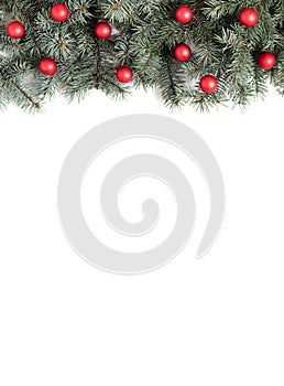 Christmas border with fir branches and red balls on a white background. Christmas decorations. View from above. Copy space