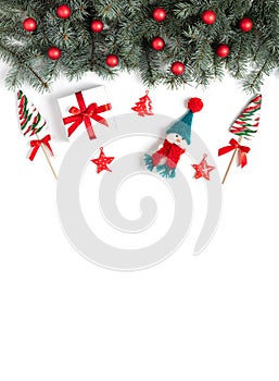 Christmas border with fir branches, snowman, lollipops and Christmas decorations on a white background. View from above. Copy