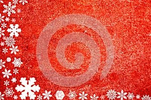 Christmas border formed from snowflakes on red natural background