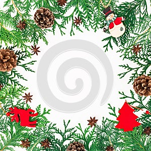 Christmas border frame of winter trees, pine cones and decoration on white background. Winter concept. Flat lay, top view