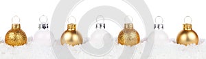 Christmas border of gold and white ornaments in snow isolated on white