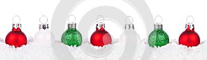 Christmas border of red, green and white ornaments in snow isolated on white