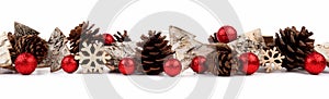 Christmas border with rustic wood tree ornaments, baubles and pine cones isolated over white