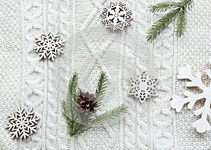 Christmas bouquet with spruce, fir-tree, snowflakes on white knitted background. Holiday card. Vintage style. F