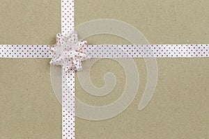 Christmas Bow and ribbon on brown paper background