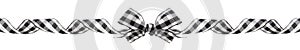 Long Christmas border of black and white buffalo plaid bow and ribbon isolated on white