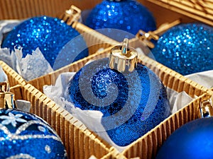 A Christmas box with blue Christmas balls and gifts, Christmas trinkets. preparing for the holiday
