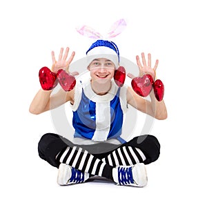 Christmas boy in blue santa hat with hearts